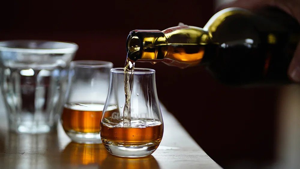 Pouring whiskey into snifter